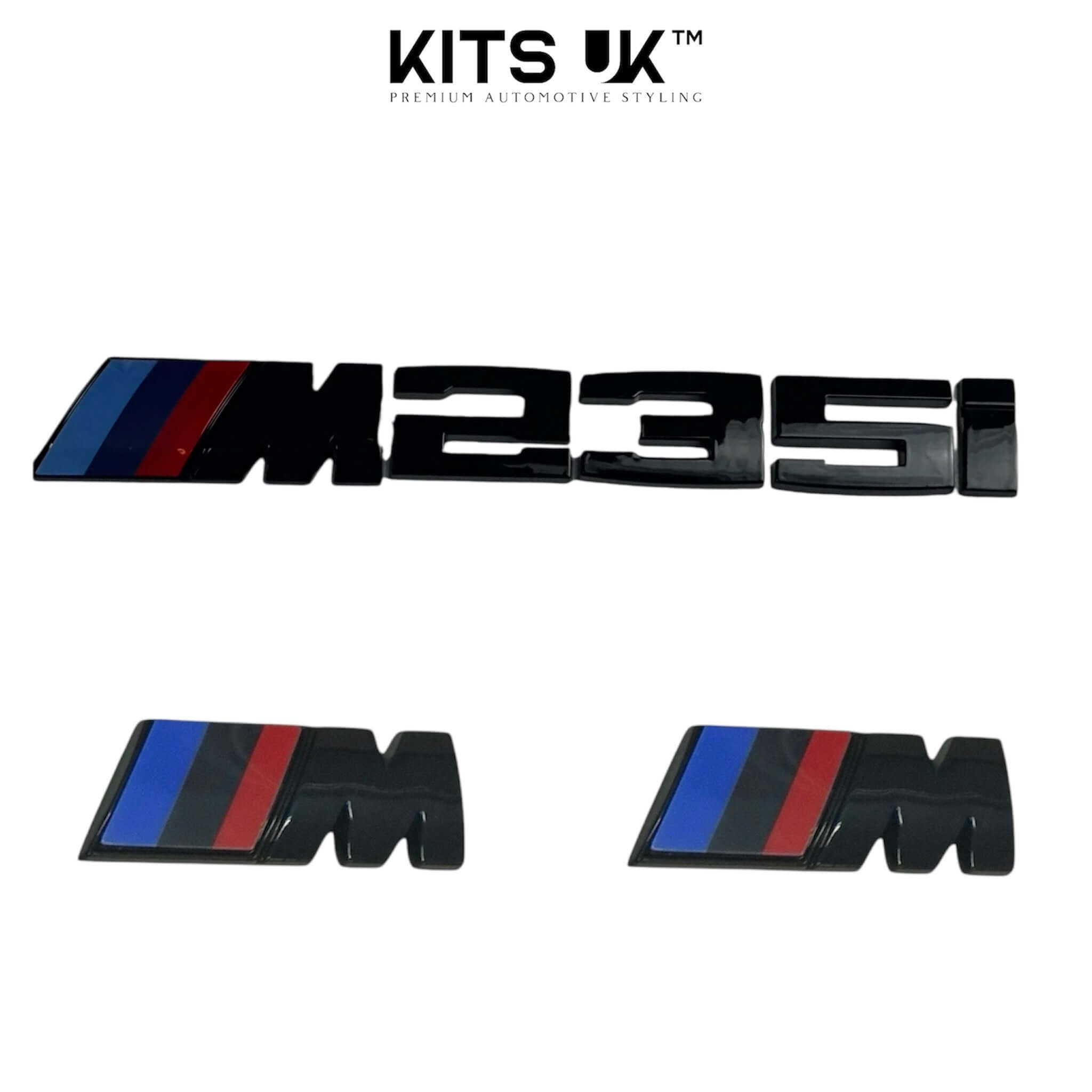 BMW RWD Black Badge Package featuring M235i and M badges in glossy black with blue and red accents.