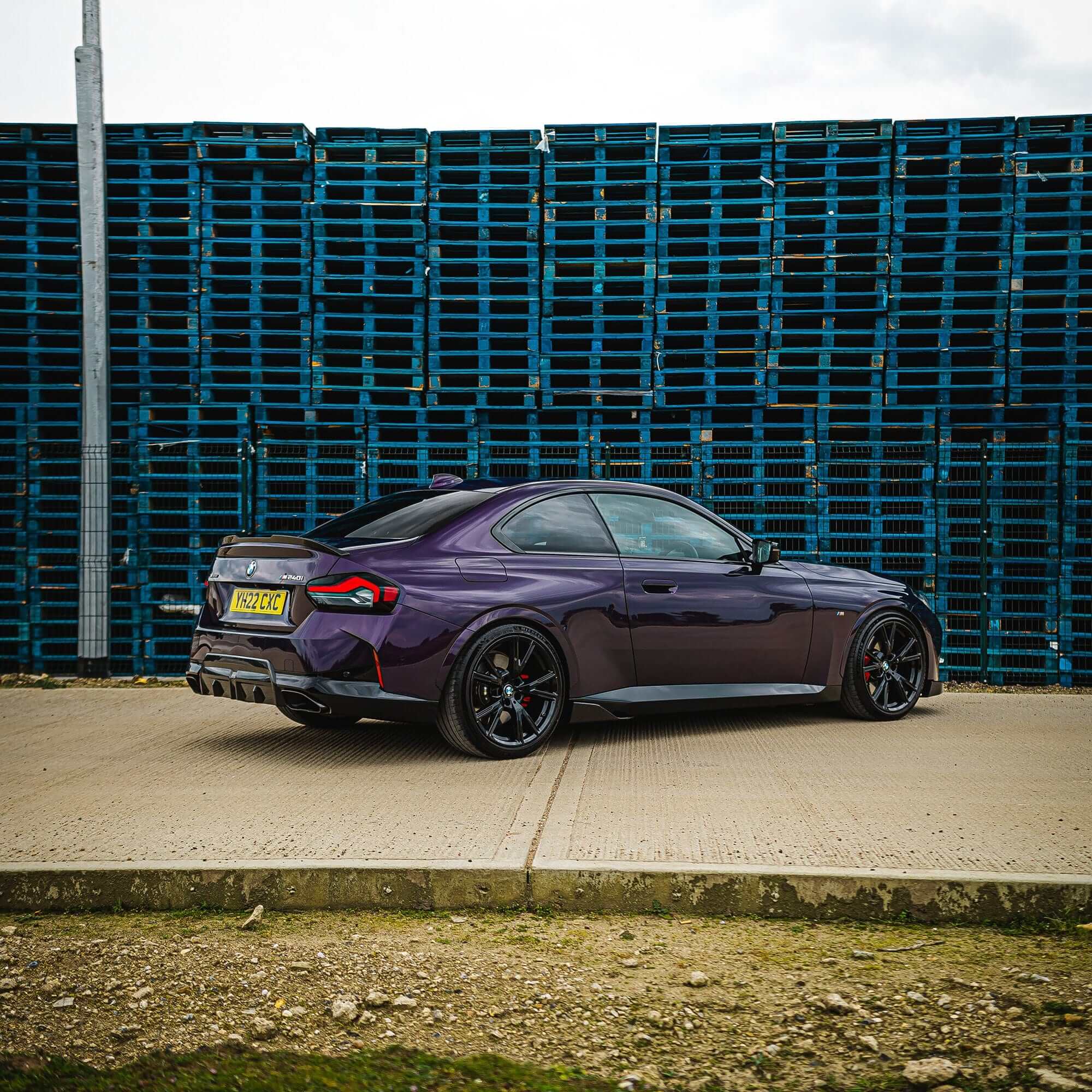 BMW G87 G42 Carbon Fibre Spoiler V2 on a BMW M2 G87 parked near blue pallets