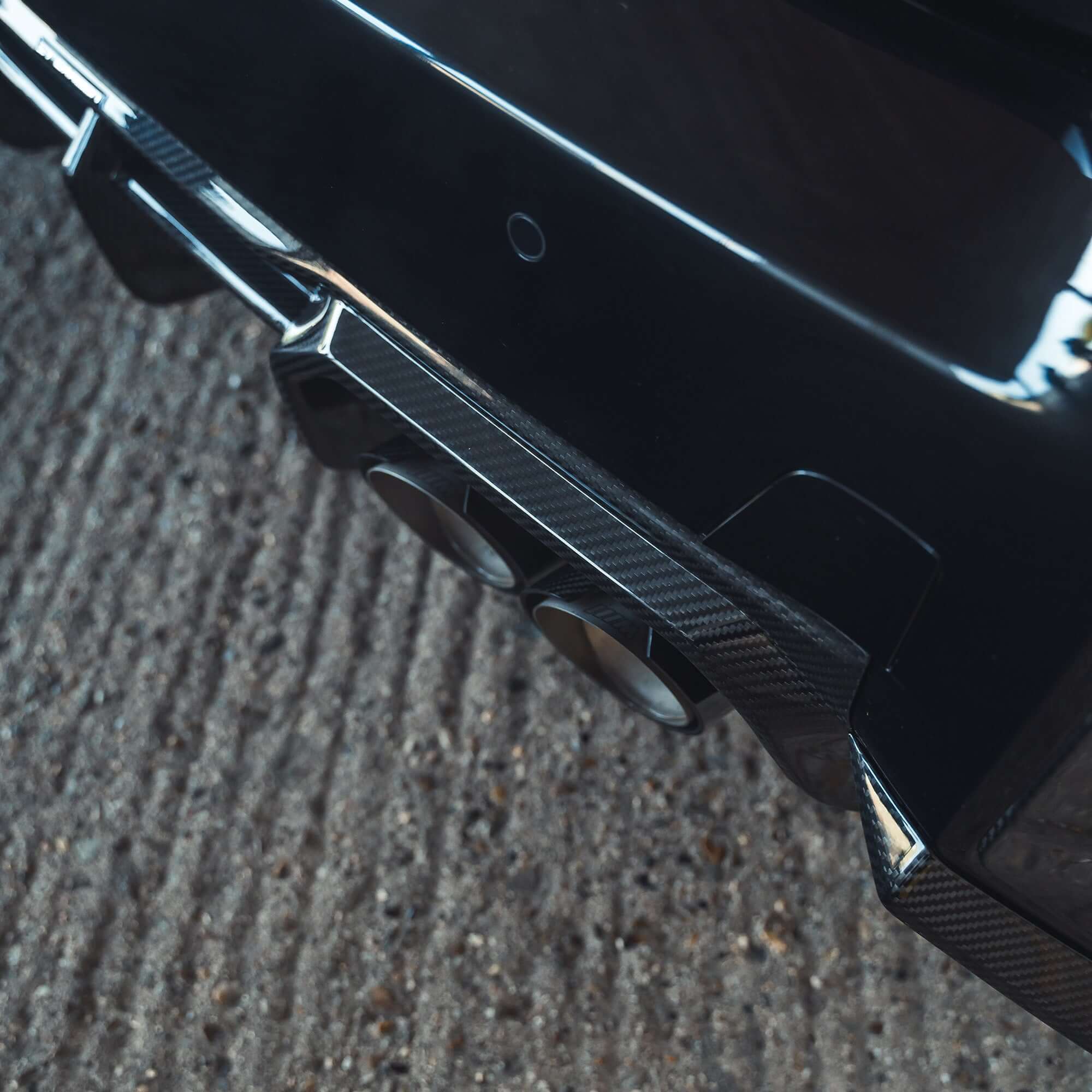 BMW G87 M2 Carbon Fibre Diffuser showcasing the sleek carbon finish and dual exhaust tips.