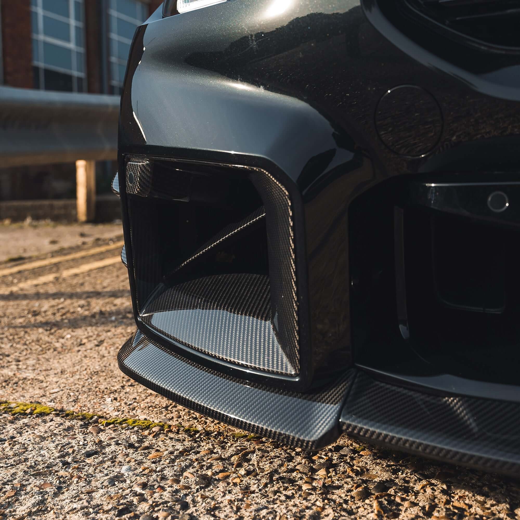BMW G87 M2 Carbon Fibre Front Splitter showcasing a sleek and aggressive front-end design.