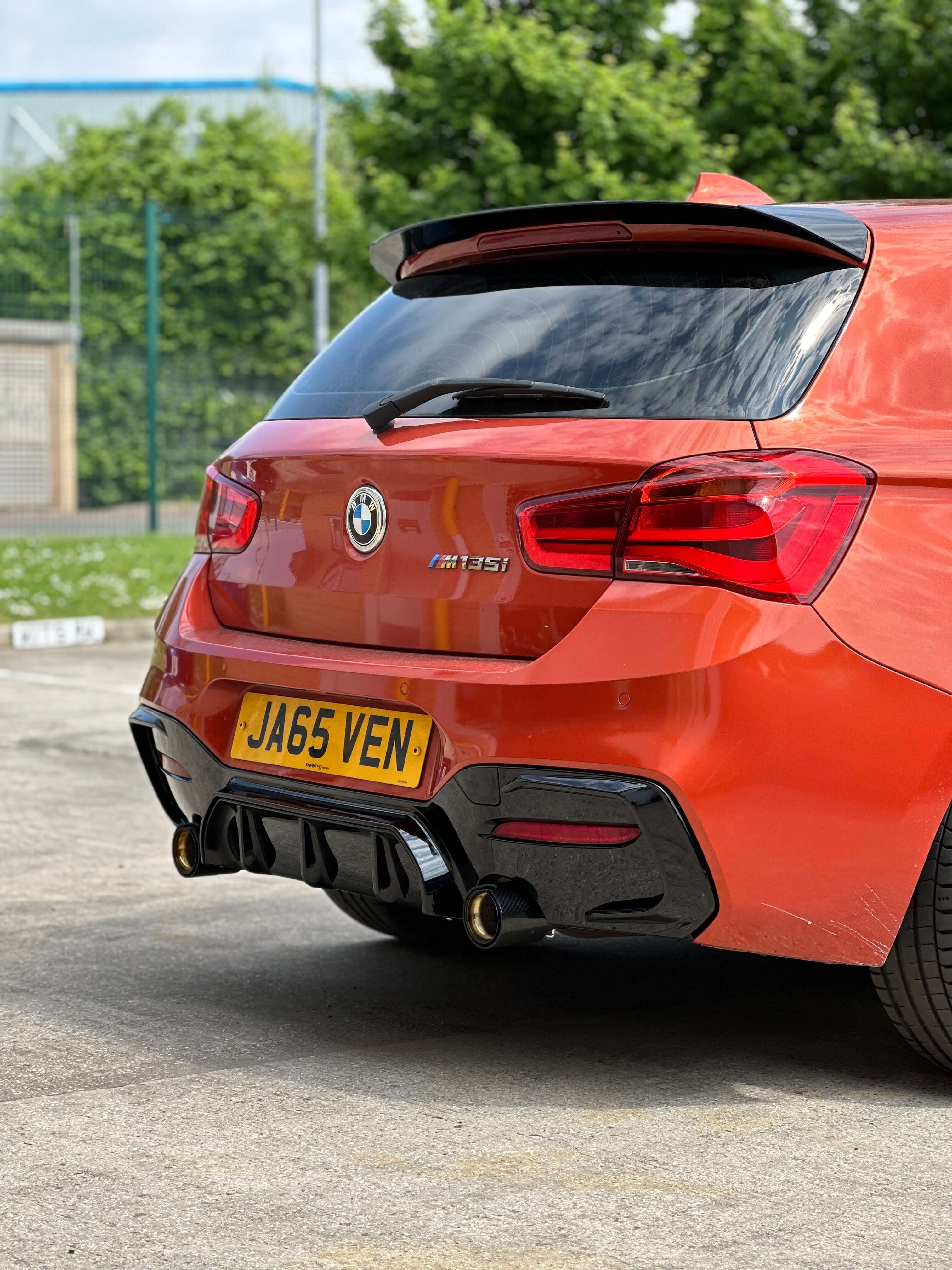 BMW F20 F21 Roof Spoiler on a BMW M135i in gloss black, enhancing sporty rear profile.