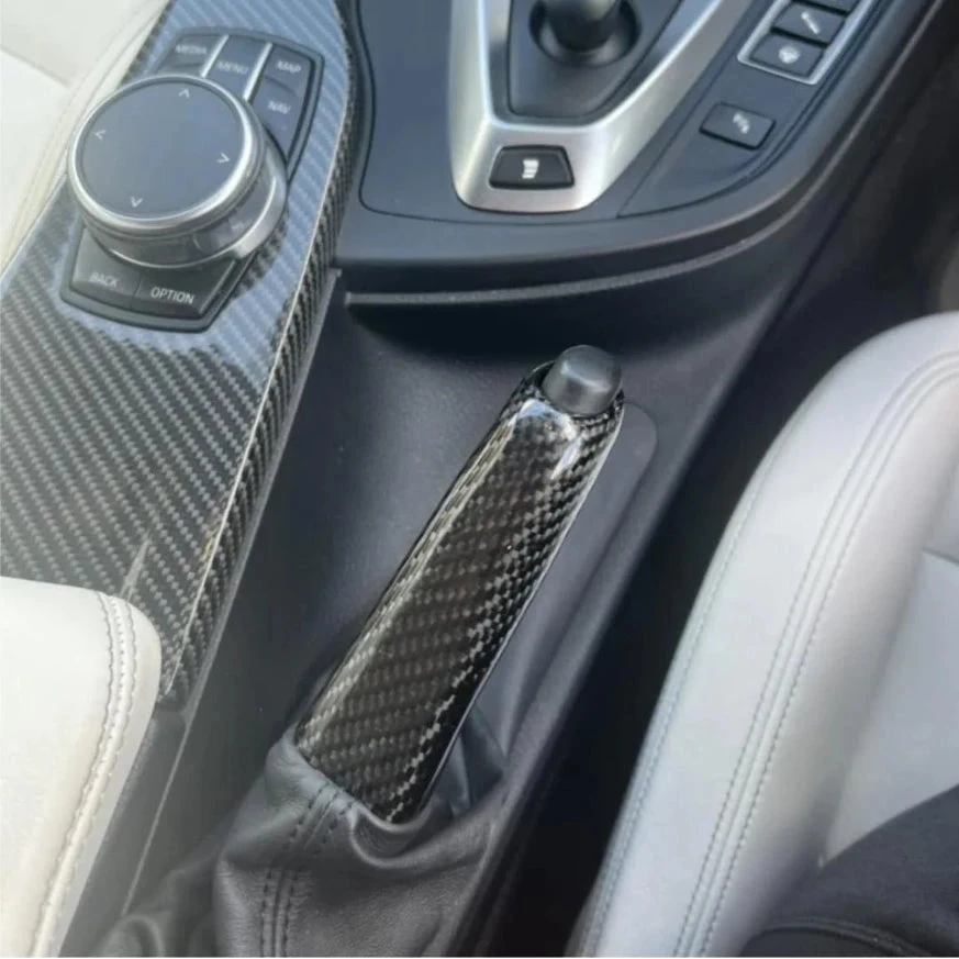 Interior view showcasing BMW carbon fibre handbrake lever F Series and gear shift console.