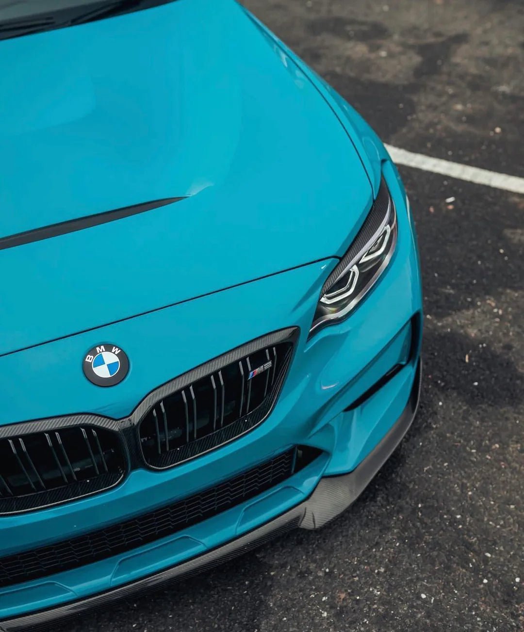 Top view of a BMW featuring BMW Dechromed Roundels on a vibrant blue car