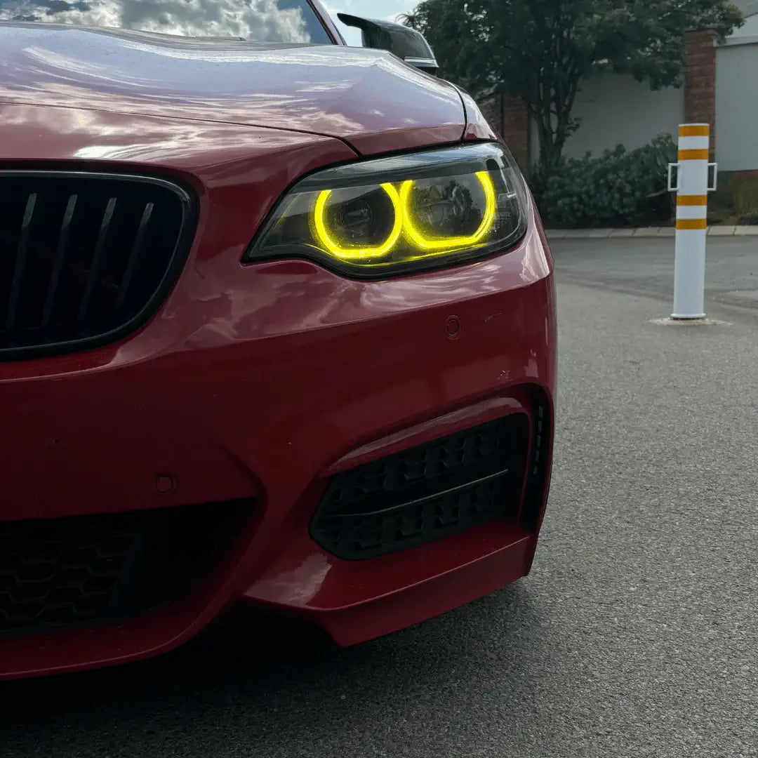 BMW Yellow DRL Modules enhancing the aggressive look of a red BMW F Series car with yellow daytime running lights.