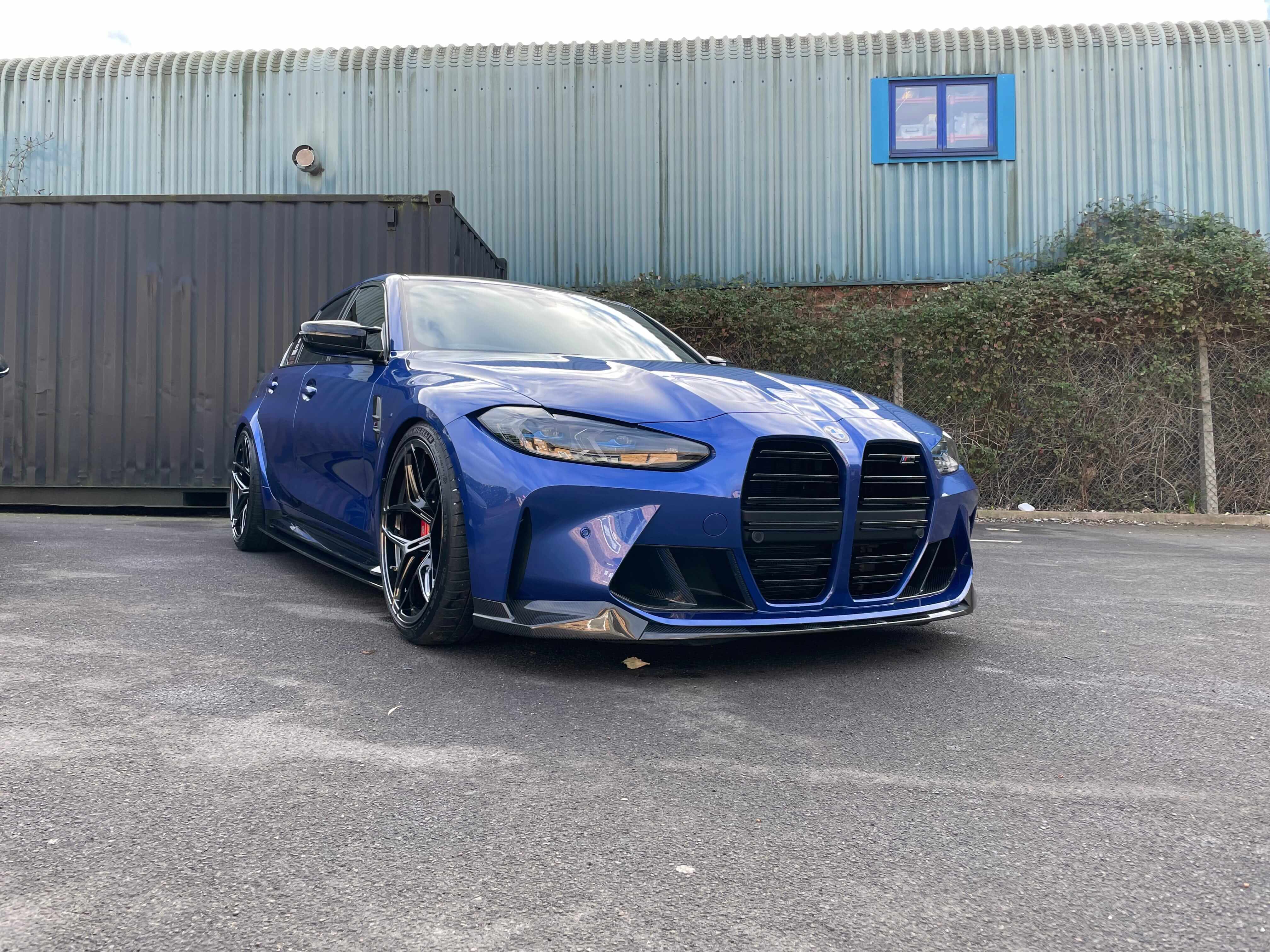 BMW G80 M3 FULL CARBON FIBRE KIT - MP STYLE showcased on a blue car with a unique aerodynamic design.