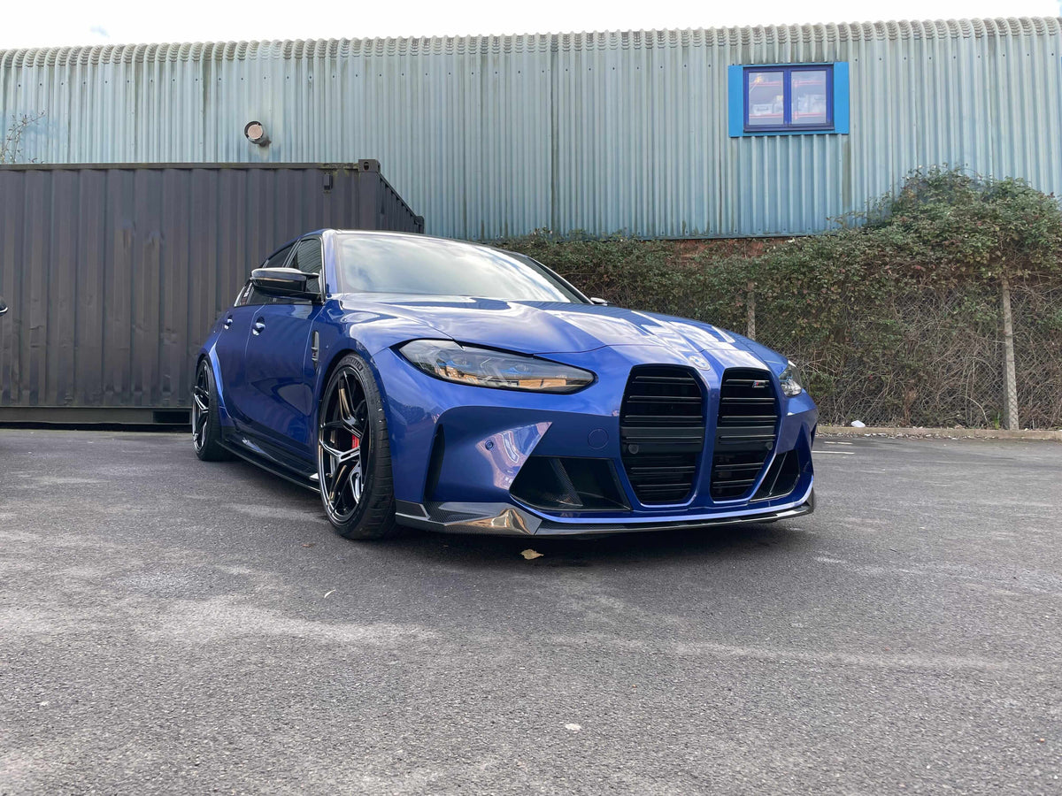 BMW G80 M3 FULL CARBON FIBRE KIT - MP STYLE showcased on a blue car with a unique aerodynamic design.