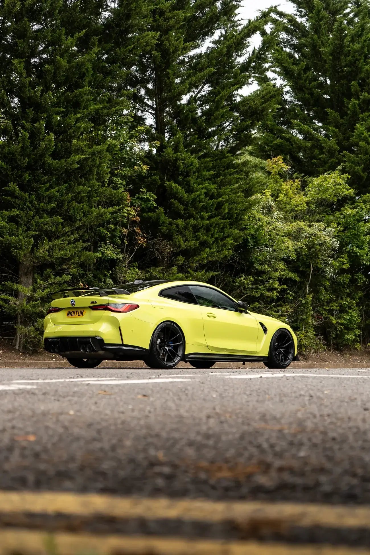 BMW M4 G82/G83 with Motech Stance Lowering Spring Kit parked on a road surrounded by trees.