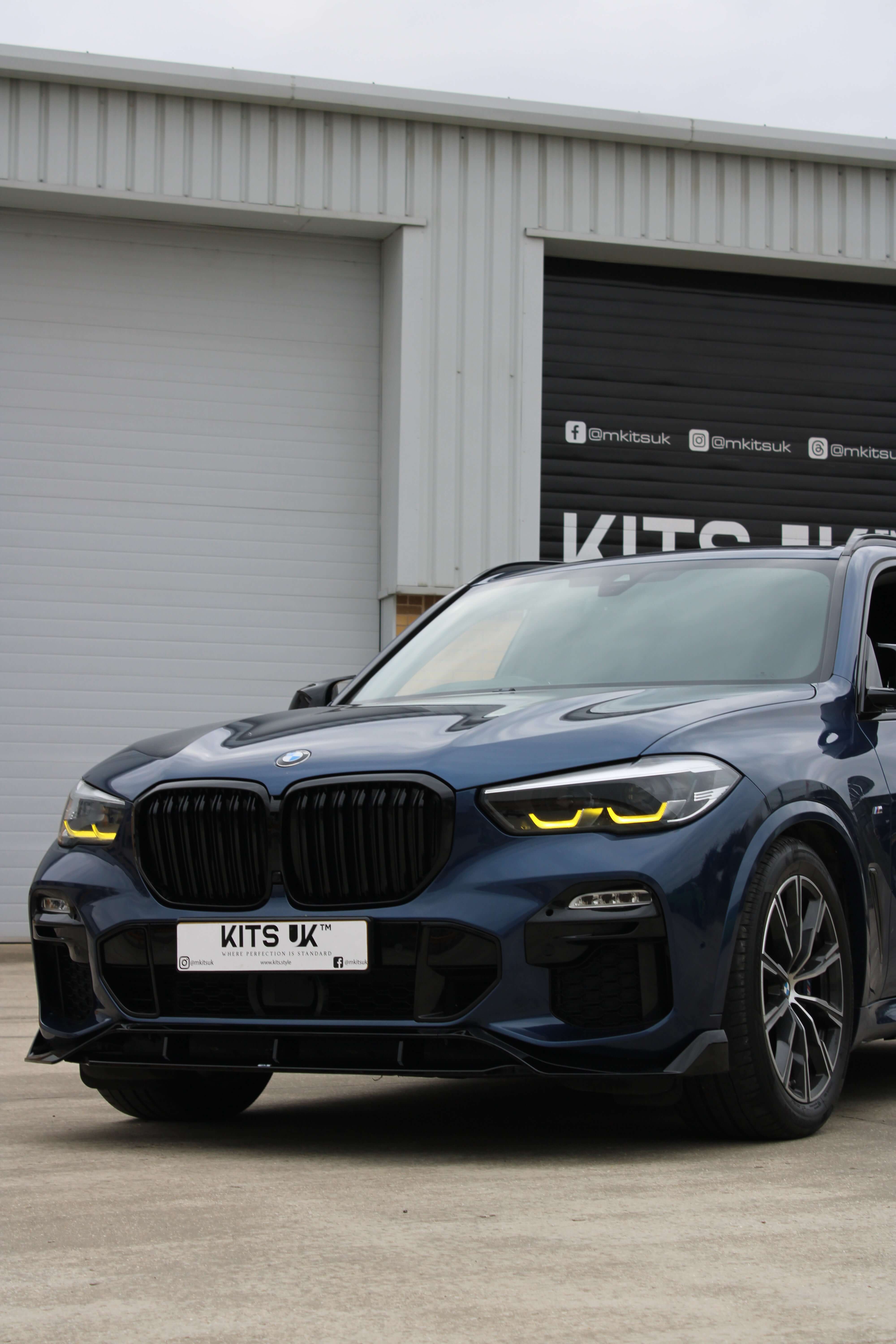 BMW Yellow DRL Modules showcased on a blue BMW X5 with aggressive styling and enhanced daytime running lights.