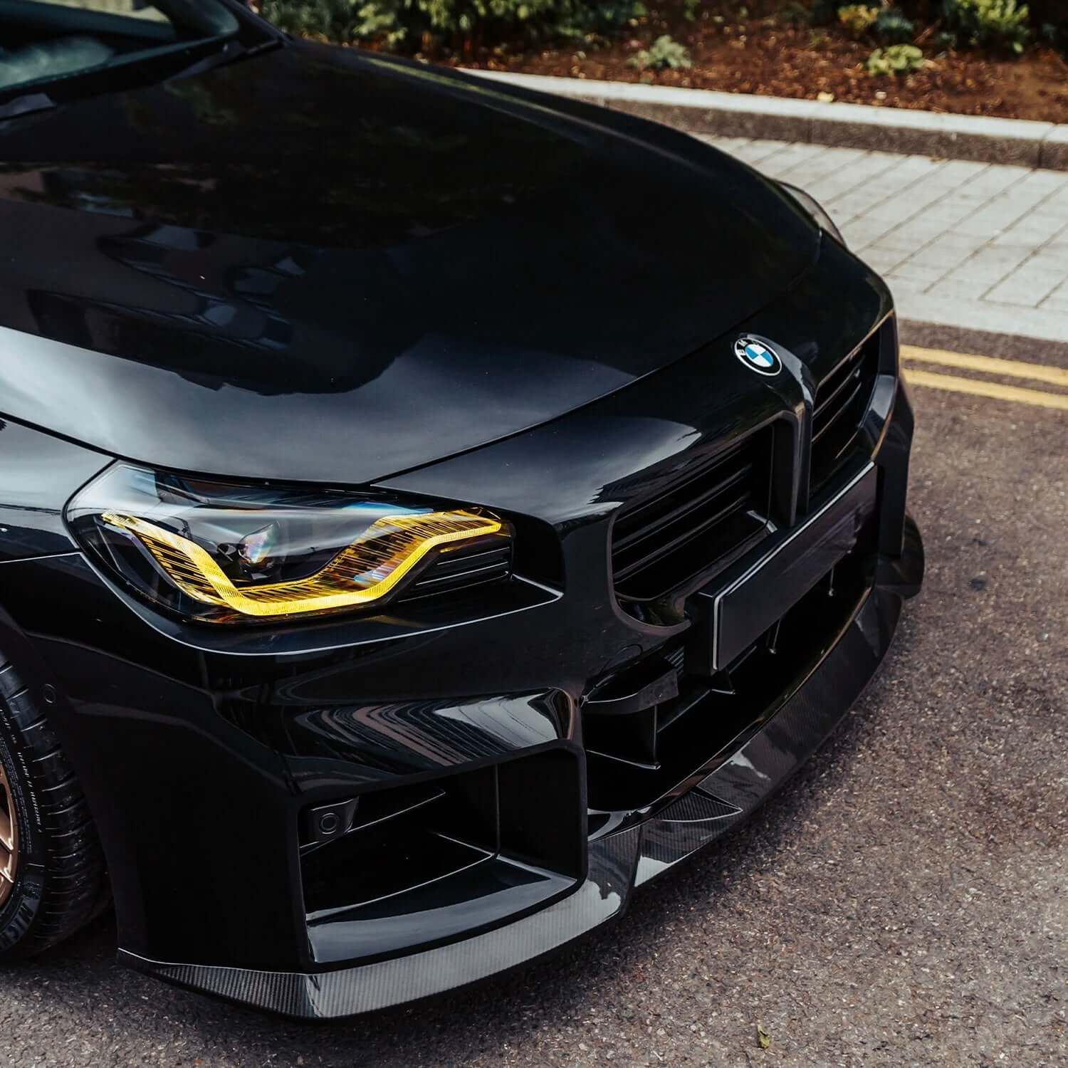 BMW Yellow DRL Modules on a black BMW showcasing aggressive styling and enhanced road presence.