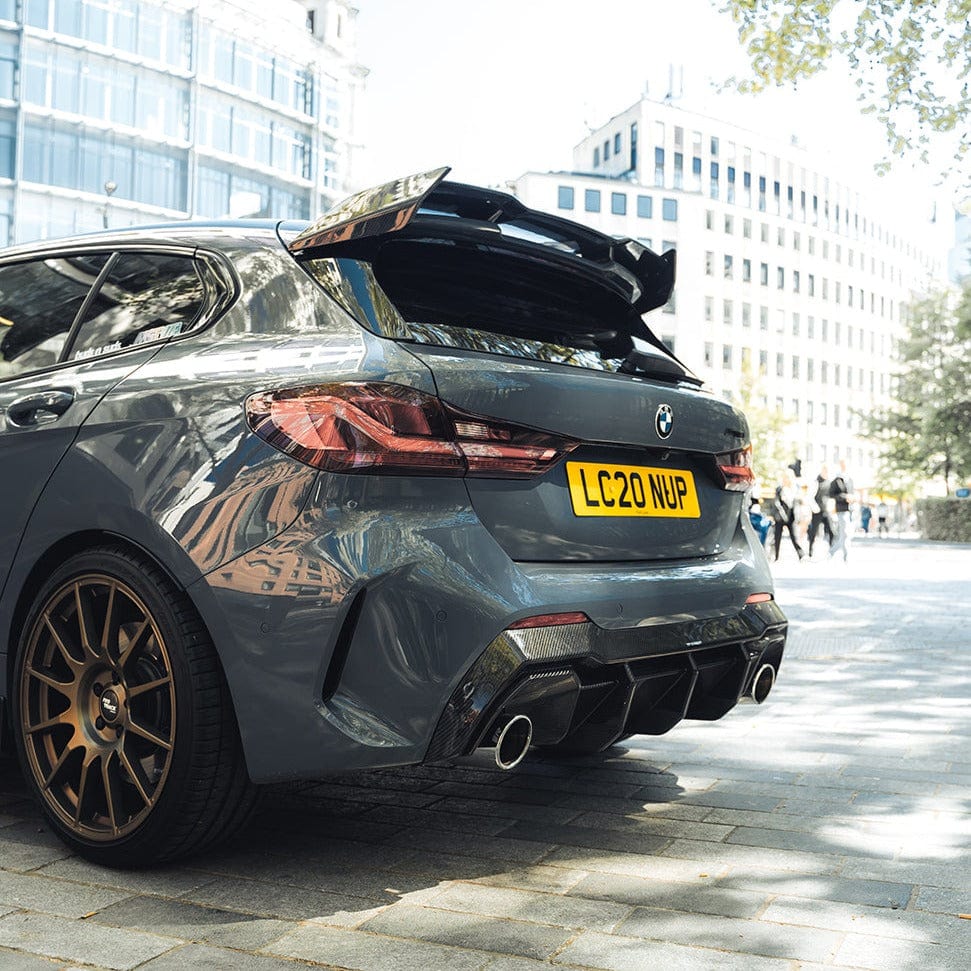 BMW F40 Carbon full body kit showcased on sleek gray BMW with aggressive rear diffuser and dual exhausts.