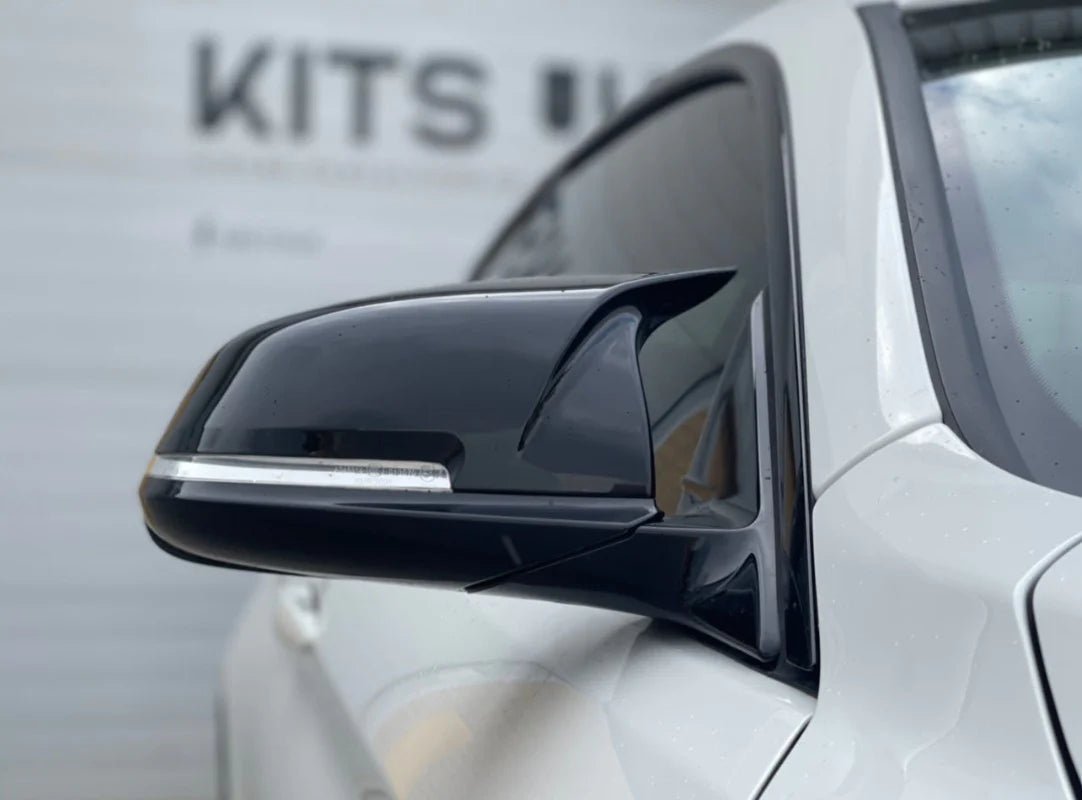 BMW F30 Ultimate Package side mirror close-up showcasing sleek black styling upgrade.