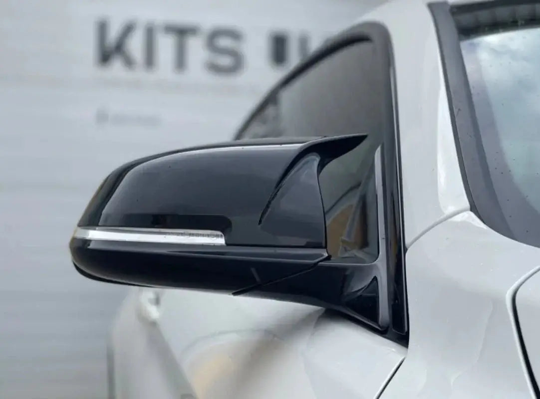 BMW F30 Ultimate Package side mirror close-up showcasing sleek black styling upgrade.