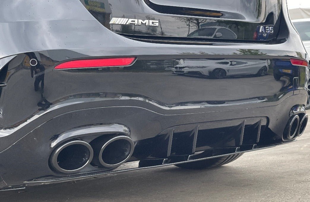 Mercedes A35 Quad Tips featuring a sleek gloss black finish on a Mercedes vehicle's aggressive rear.
