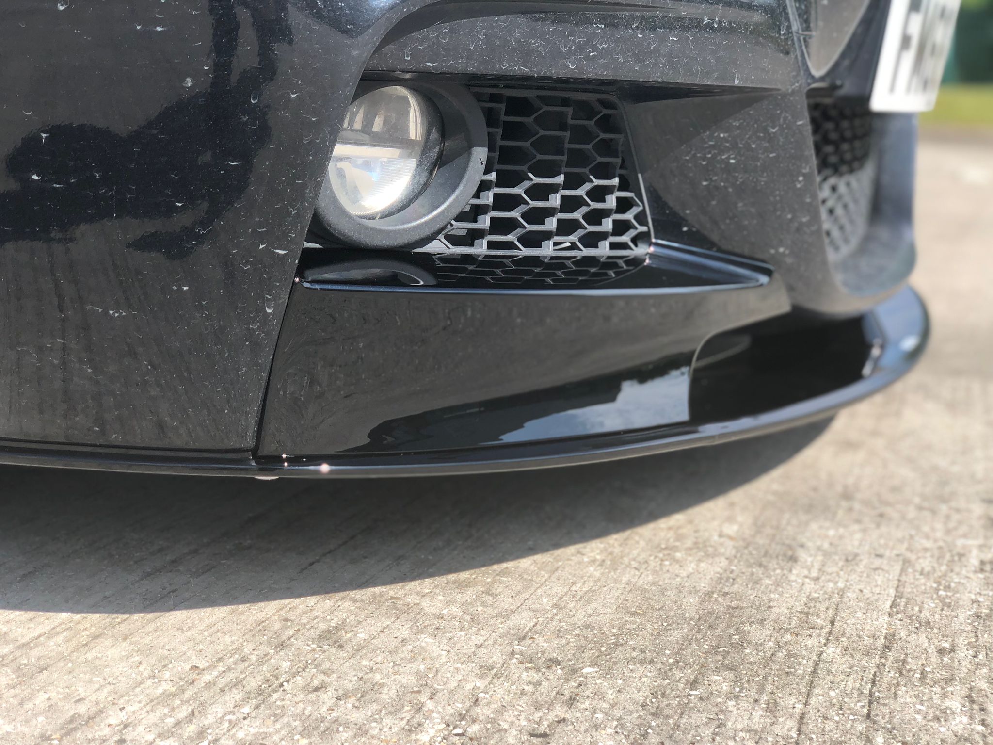 BMW F31 Touring body kit close-up showing front splitter and grille details for M Sport models.
