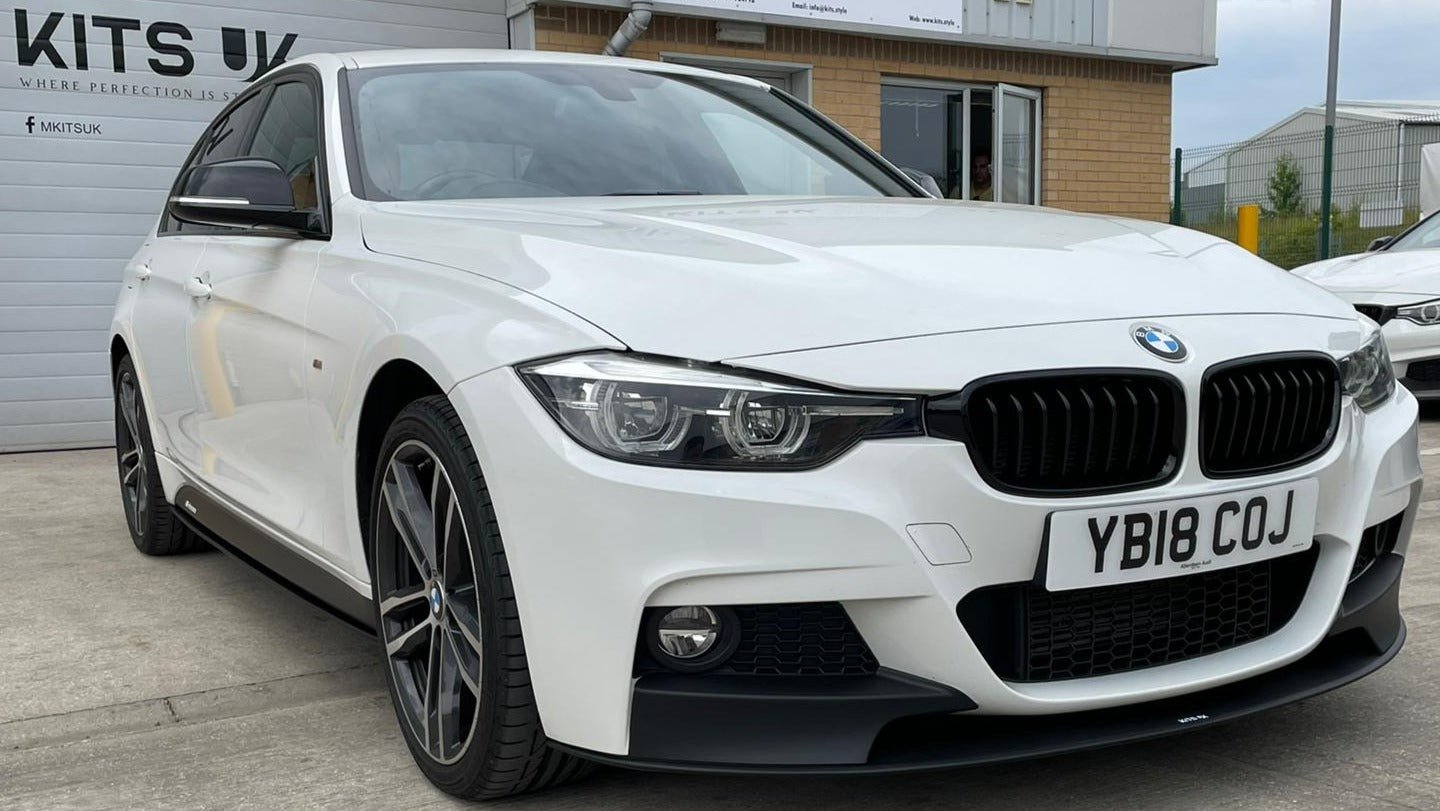 BMW F30 Performance Package on a white BMW 3 Series showcasing its front styling and aerodynamic features.