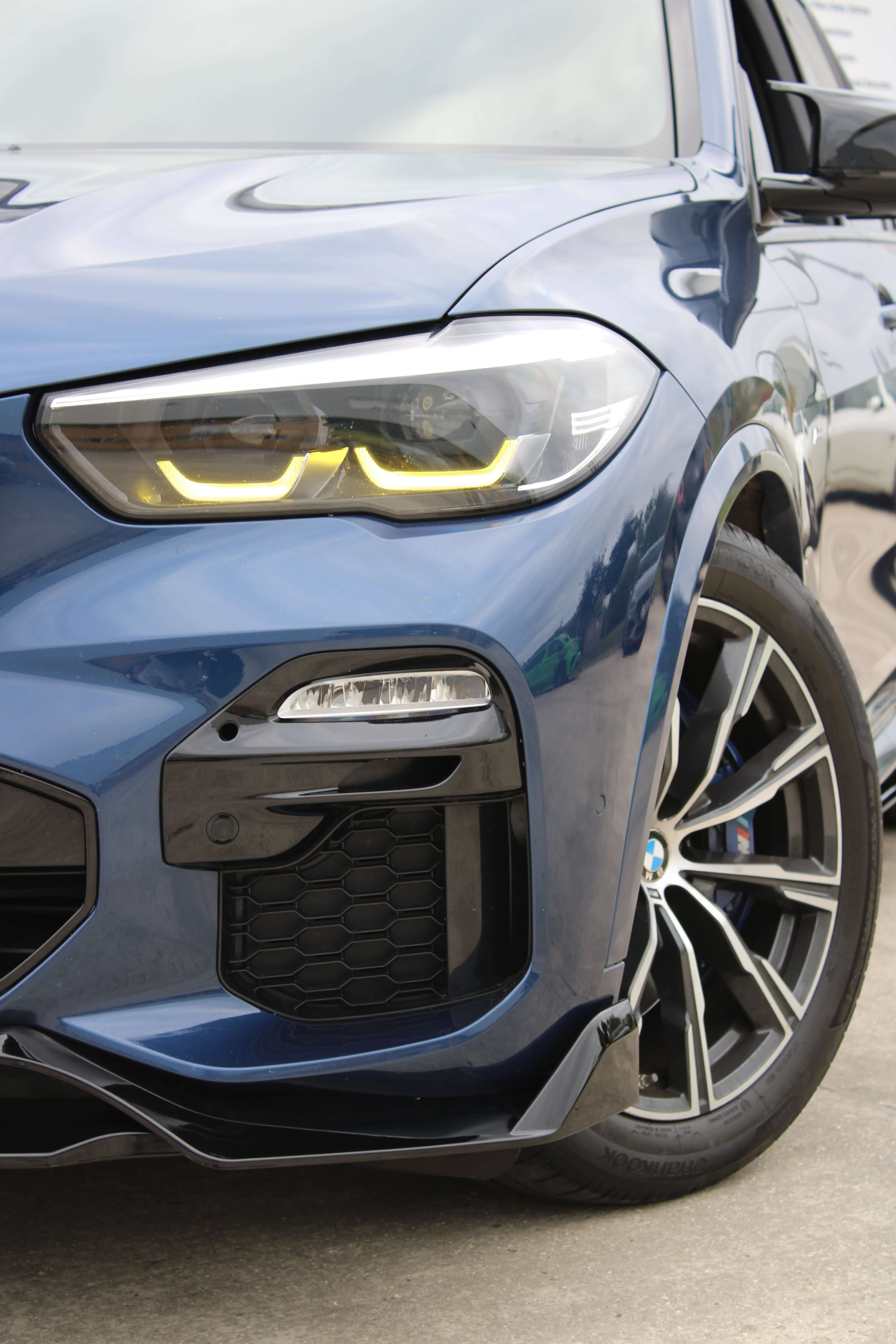 BMW yellow DRLs illuminating with a vibrant yellow glow, highlighting the design and functionality.