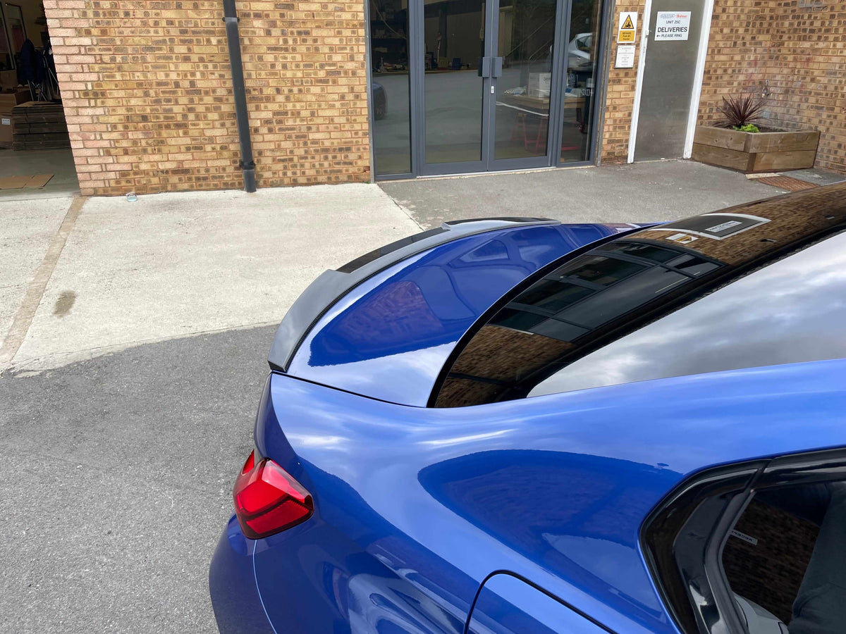 BMW G80 M3 FULL CARBON FIBRE KIT - MP STYLE rear view showcasing the stylish spoiler on a blue M3.