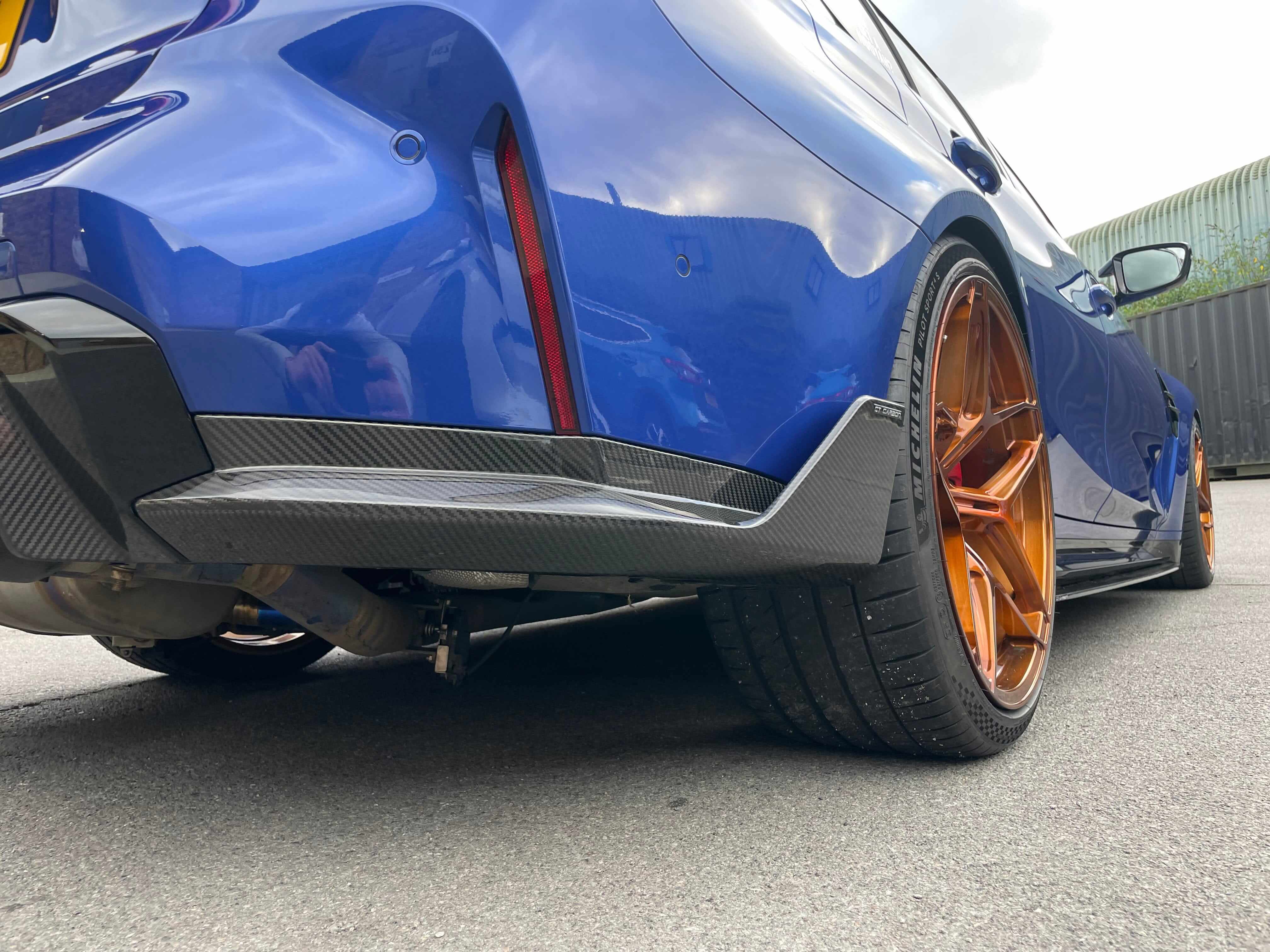 BMW G80 M3 FULL CARBON FIBRE KIT - MP STYLE detailed view of rear bumper and carbon fibre diffuser.