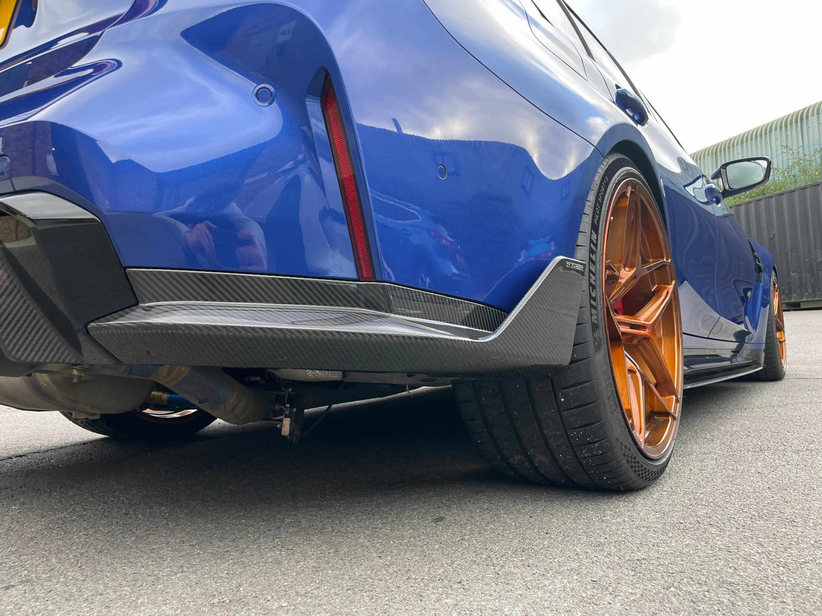 BMW G80 M3 FULL CARBON FIBRE KIT - MP STYLE detailed view of rear bumper and carbon fibre diffuser.