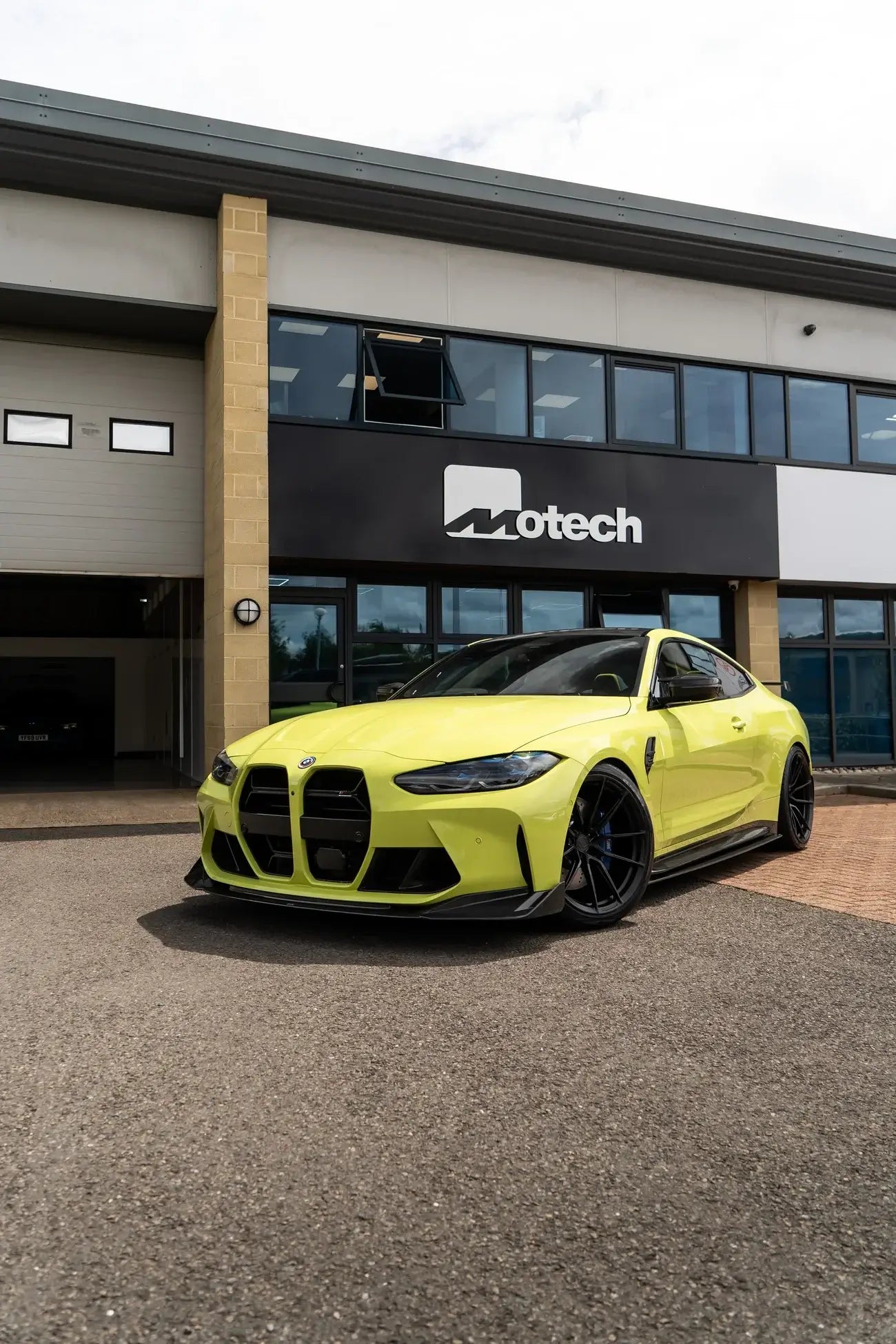 BMW M4 G82/G83 with Motech Stance Lowering Spring Kit in a vibrant yellow at Motech headquarters.